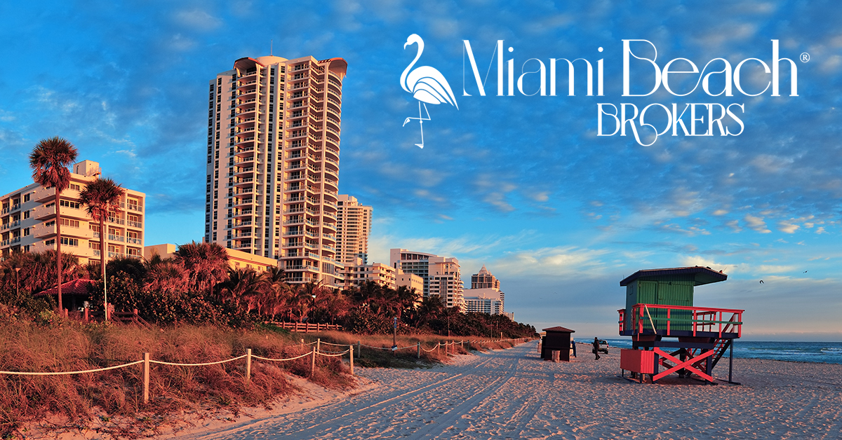 Sunrise on Miami Beach, facing north, with the dunes & beachfront condominiums and hotels to the left and the sand, surf and lifeguard house to the right.
